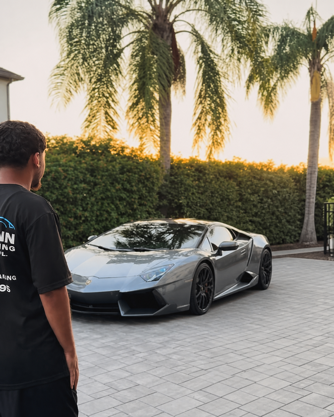 Precisionn Detailing specialist beside a silver Lamborghini